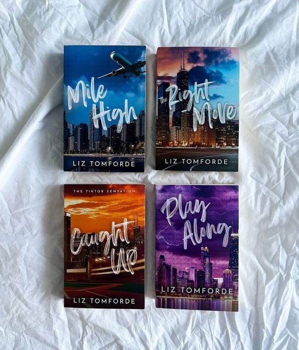 Four books by Liz Tomforde on a textured white surface